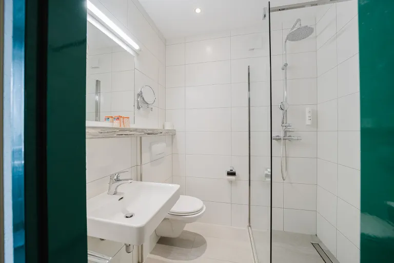 View into the modern bathroom with shower at Motel Baden
