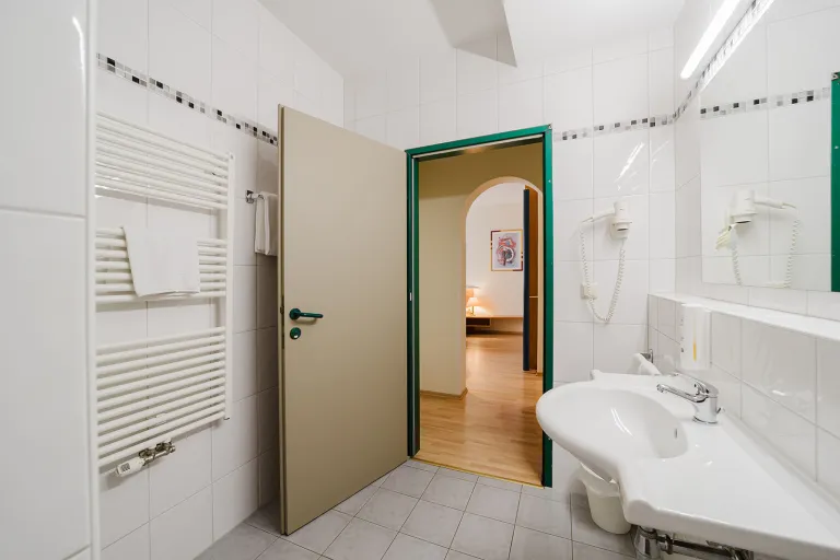 Bathroom with vanity and hairdryer at Motel Baden