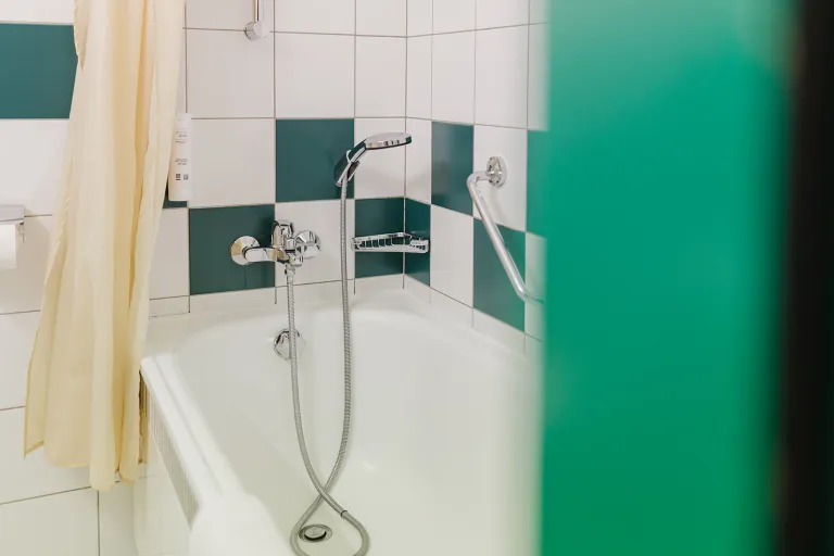 Bathtub with hand shower at Motel Baden