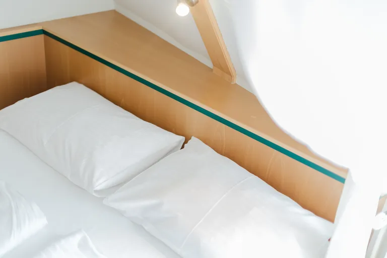 Bed under the sloping roof at Motel Baden