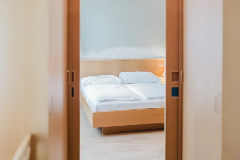 View through the room door onto the bed at Motel Baden