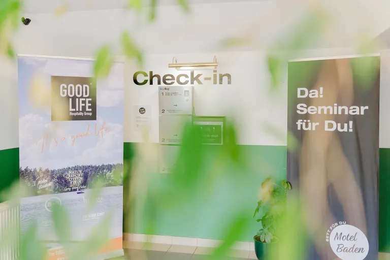 Check-in area with roll-up banners at Motel Baden