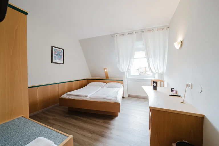 Attic double room with double bed and desk at Motel Baden