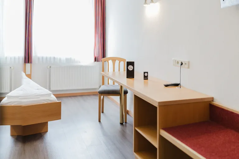 Window bench and desk in the double room with private garage at Motel Baden