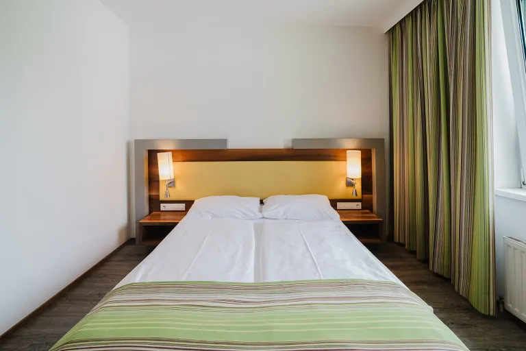 Double bed with reading lights at Motel Baden