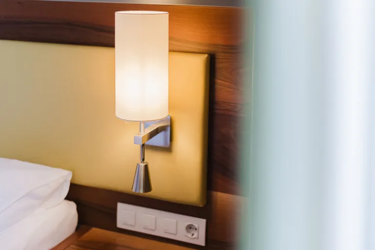 Bedside lamp next to the bed at Motel Baden