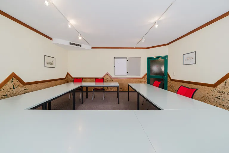 Small seminar room on the ground floor with tables in block layout at Motel Baden