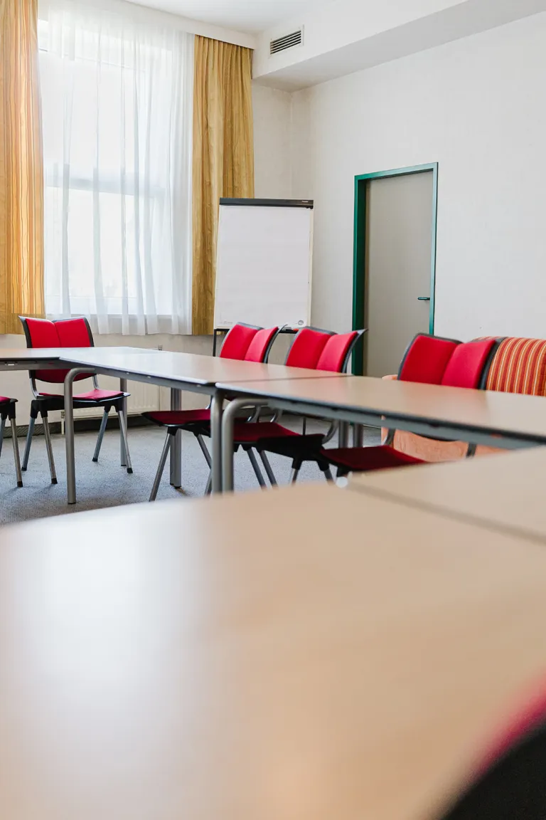 Large seminar room with tables and flipchart at Motel Baden