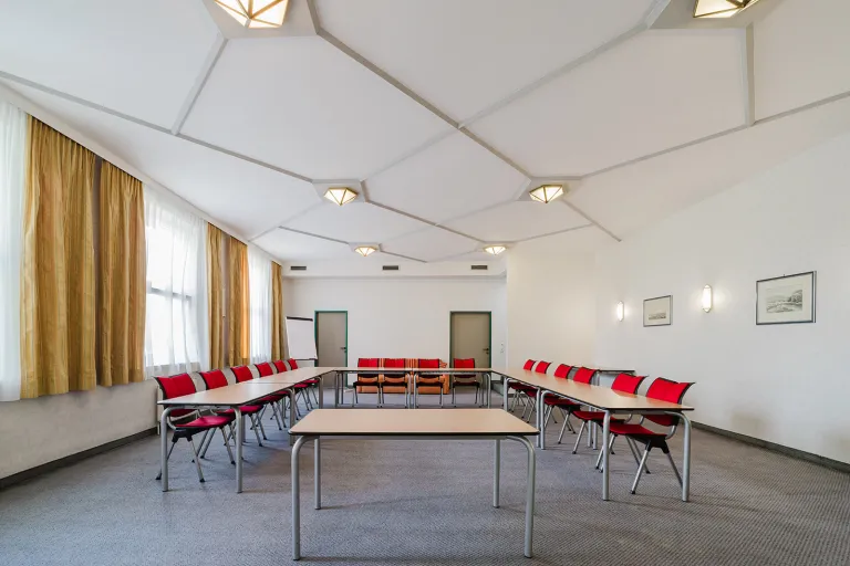 Large seminar room on the 1st floor with rows of tables at Motel Baden