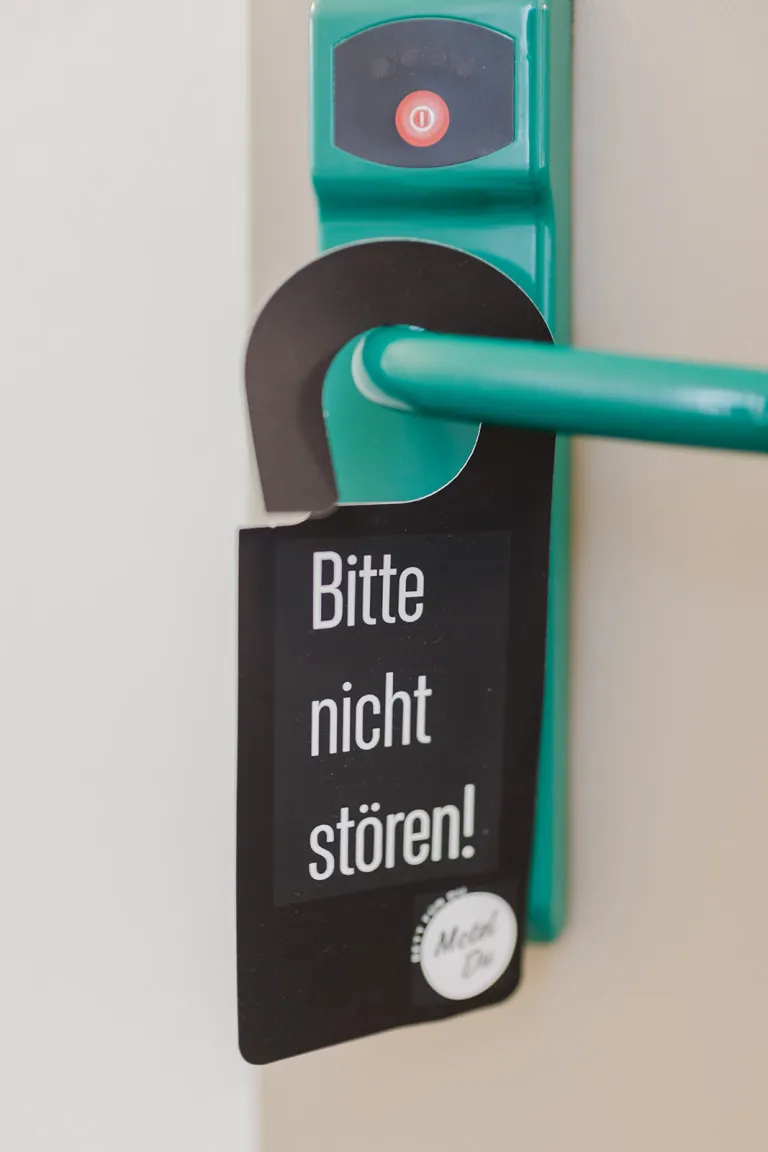 "Please do not disturb!" door hanger on the door handle at Motel Baden