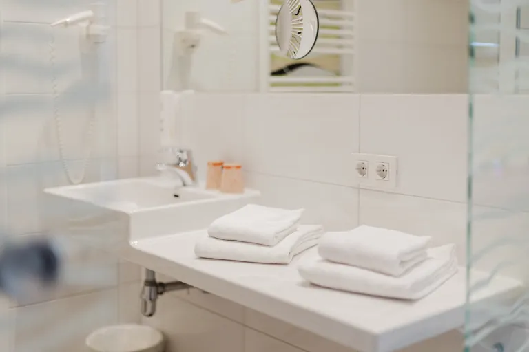 Vanity with fresh towels at Motel Baden