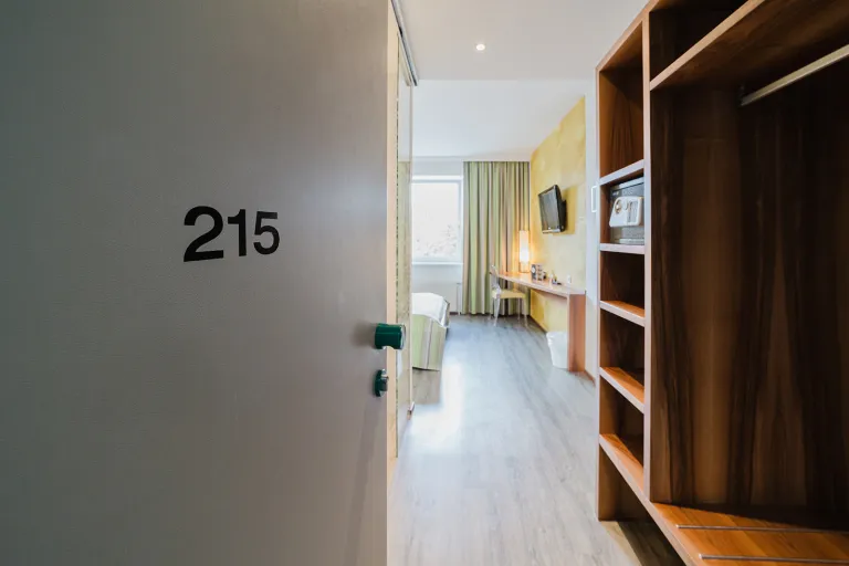 Open door of room 215 with a view into the room at Motel Baden